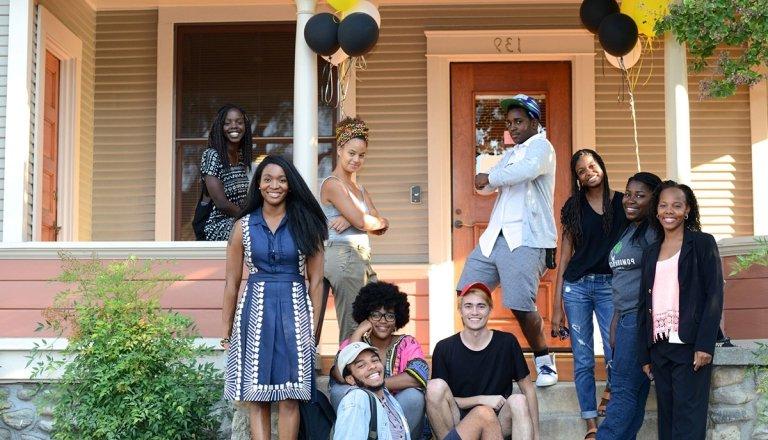 office of black student affairs students pose outside the office's bungalow